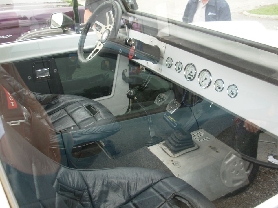 Custom Bronco interior with six chrome gauges, Hurst shifter and leather buckets