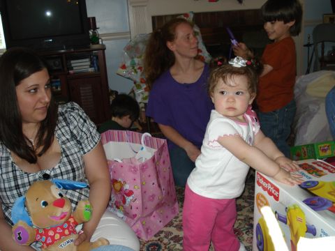 2000 Ford Crown Victoria - A family celebrates indoors, with a baby and toys as the focus.
