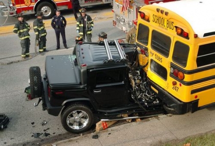 1991 Ford Crown Victoria - A collision occurred between a black Hummer H2 and a yellow school bus, with emergency personnel present.