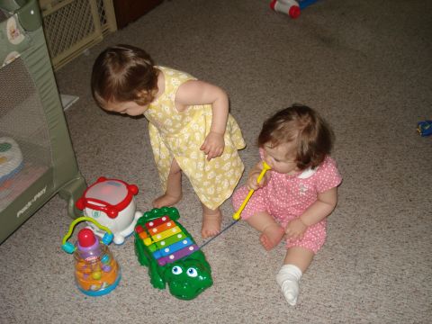 2000 Ford Crown Victoria - Two young children play with various toys on a carpeted floor.