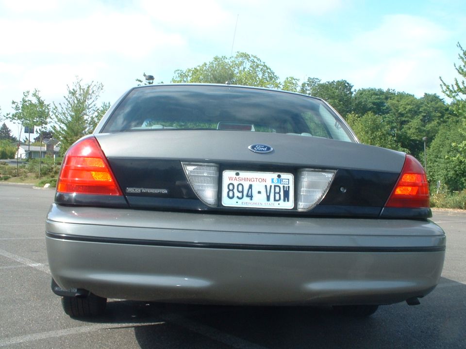 Rear view of a gray Ford Crown Victoria Police Interceptor with license plate 894-VBW.
