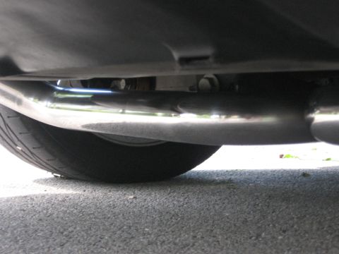 1998 Ford Taurus - Close-up view of the exhaust system and undercarriage of a vehicle.