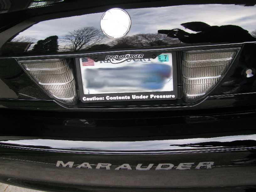 Rear view of a black sedan with a license plate and "MARAUDER" lettering.