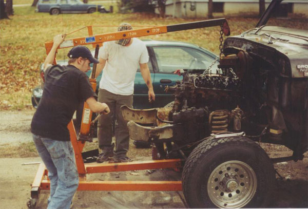 Engine being lifted by an engine hoist from a vehicle