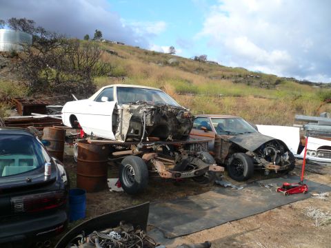 1975 Ford Ranchero - A white 1970s coupe body is stripped down and mounted on a trailer chassis, with a brown coupe body in front of it. The vehicles are in an…
