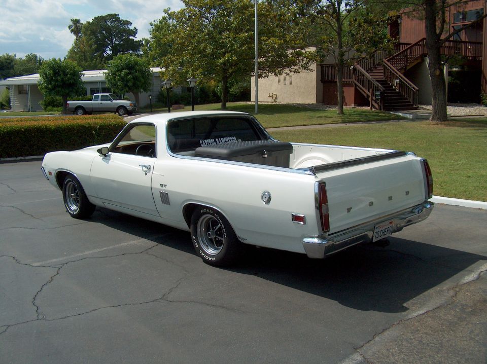 White 1970 Ford Ranchero with a black toolbox in the bed, parked outdoors.