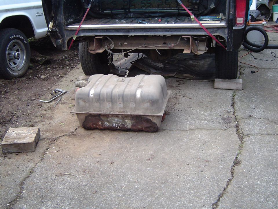 Taking the gas tank out as its a leaker, and it hangs down too low.