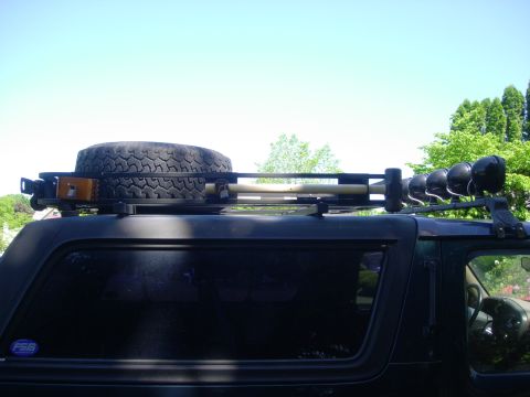 1993 Ford Bronco - This 1993 Ford Bronco is equipped with a roof rack a spare tire, shovel, and auxiliary lights.