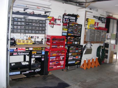 1993 Ford Bronco - Organized garage workshop filled with tool chests, a workbench, and various automotive parts storage.
