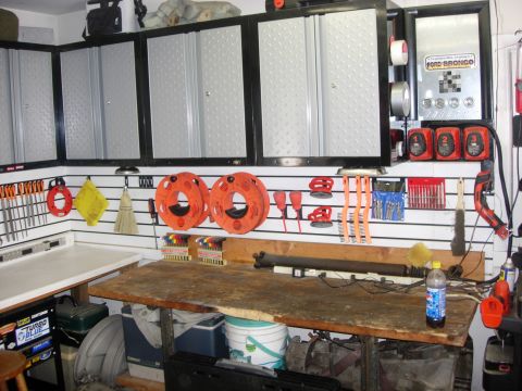 1993 Ford Bronco - Workbench area in a garage, tool storage and a decorative Ford Bronco sign.
