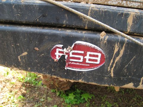 1996 Ford Bronco - A close-up shows a damaged sticker on a dirty vehicle bumper, with text indicating "FullSizeBronco.com".