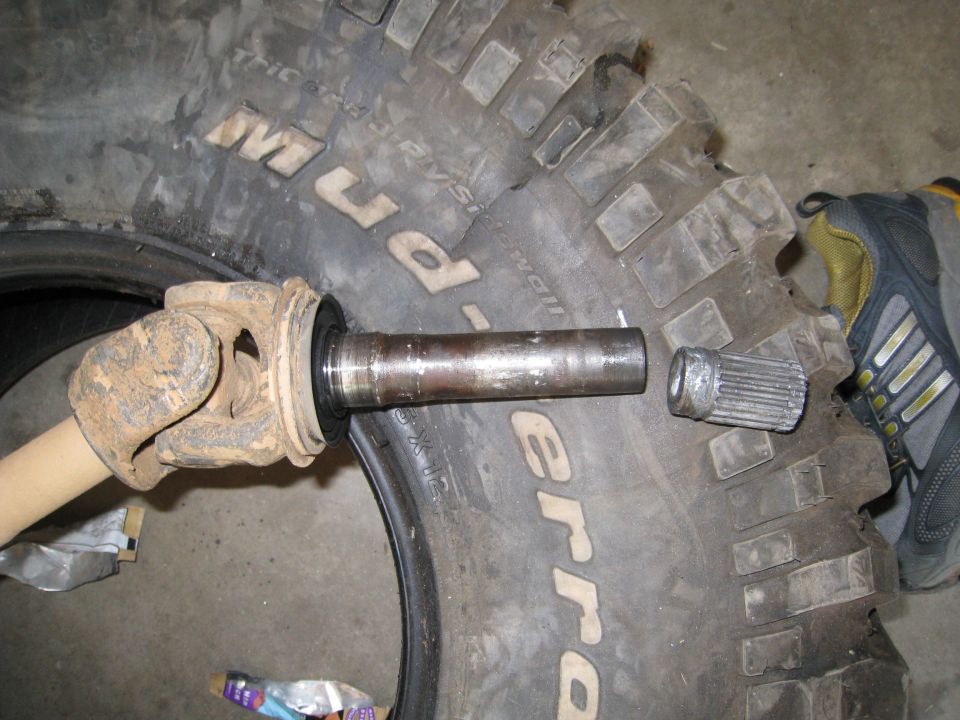 Driveshaft U-joint and splined shaft next to BFGoodrich Mud-Terrain tire