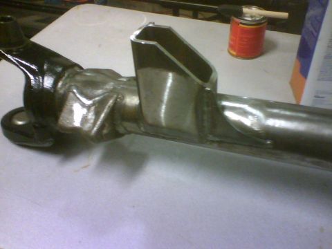 1993 Ford Bronco - A close-up view of a modified suspension part, likely for an off-road vehicle, with visible metal fabrication.