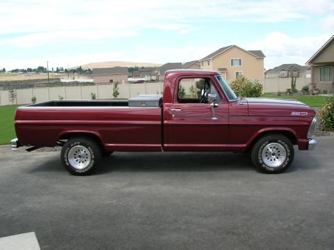 1967 Ford F-100 - This maroon Ford F-100 pickup truck is parked in a suburban driveway on a clear day.