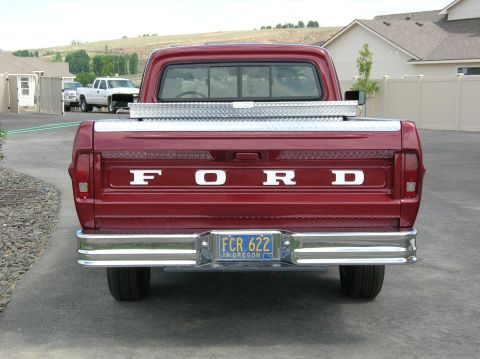 1967 Ford F-100 - Rear view of a red Ford F-100 pickup truck with a diamond plate toolbox in the bed.