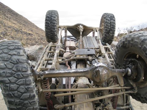 1994 Jeep YJ - The underside of a custom off-road vehicle is shown in a desert landscape.