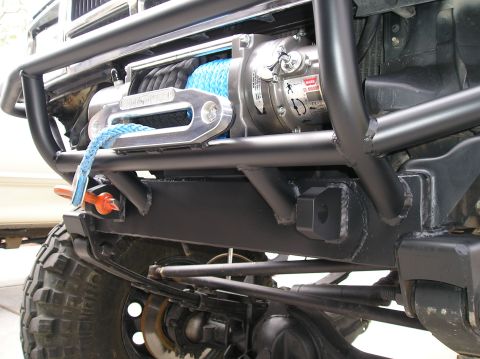 1986 Toyota Hilux - Close-up of a vehicle's front end, showing a winch and heavy-duty bumper assembly.