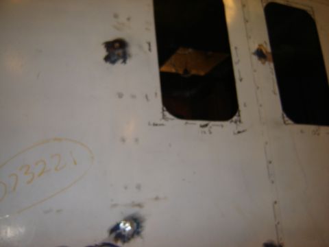 1992 Ford Bronco - A white panel with two dark, rectangular openings and some handwritten markings, including '023221'.