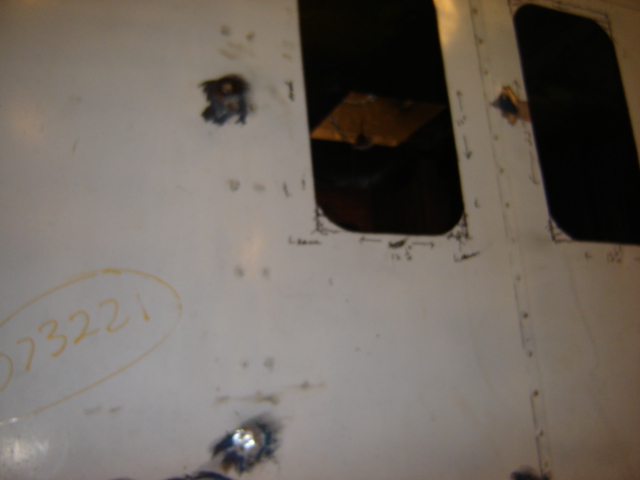 White panel with two dark windows, one with yellow markings '023221'