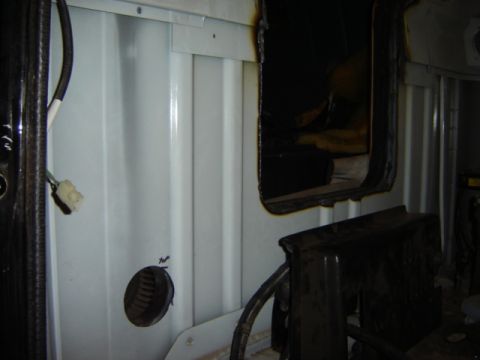 1992 Ford Bronco - Close-up view of the interior of a vehicle, showing paneling, wiring, and a dark opening.