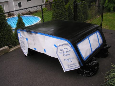 1995 Ford Bronco - A car roof is taped off and covered with paper, ready for painting, with a "Think Safety Buckle Up" tag attached.
