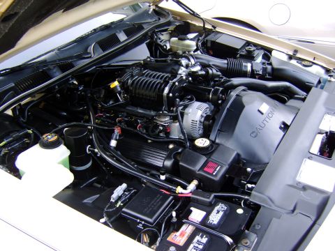 1996 Mercury Grand Marquis - The engine bay of a car is shown with various components clearly visible.