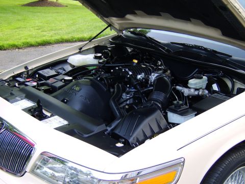 1996 Mercury Grand Marquis - Engine bay of a 1996 Mercury Grand Marquis, showing the V8 fan shroud and various engine components.