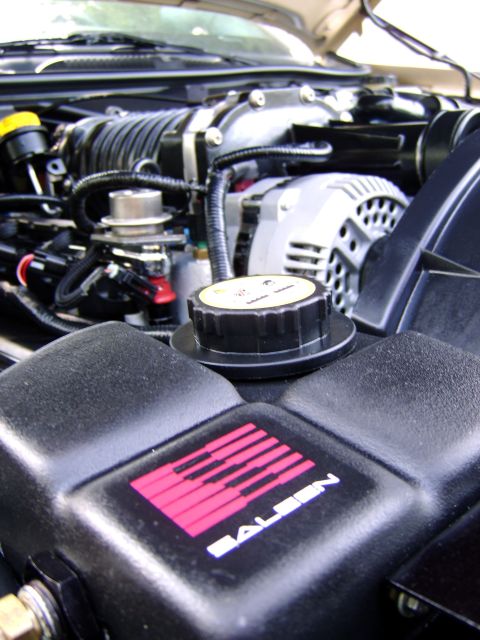 1996 Mercury Grand Marquis - The engine bay features a supercharger and a prominent Saleen logo on a component.