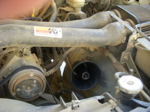 1989 Ford Bronco - Close-up view of the engine bay, highlighting the air intake system and various engine components.