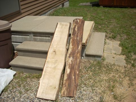 2000 Chevrolet Tahoe - Lumber and a log are placed on concrete steps outside a building.