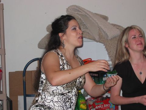 1985 Ford LTD Crown Victoria - Two women are enjoying a party, with one holding a small cup of green dessert.