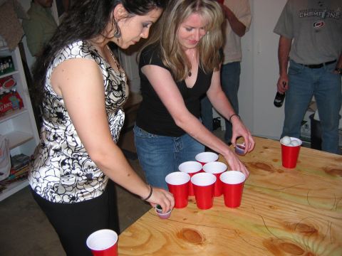 1985 Ford LTD Crown Victoria - People gathered for a game of beer pong indoors.