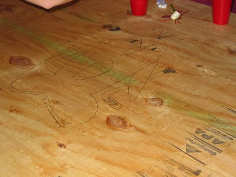 1985 Ford LTD Crown Victoria - Photograph of a doodle on a plywood table, not a technical document.