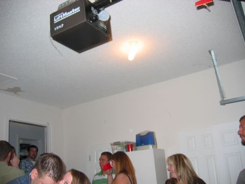 1985 Ford LTD Crown Victoria - Photograph of a party in a garage, not a technical document.