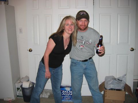 1985 Ford LTD Crown Victoria - Photo of two people posing at a party, one holding a beer bottle, not a technical document.