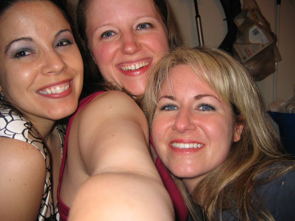 Three women taking a selfie together at a party