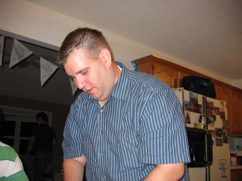 1985 Ford LTD Crown Victoria - Photo of a man at a kitchen party, not a technical document.