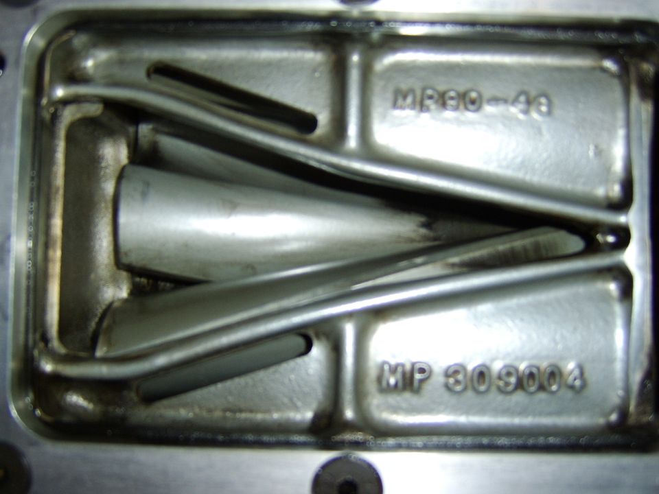 Cast aluminum manifold interior with runners and cast markings MP 309004