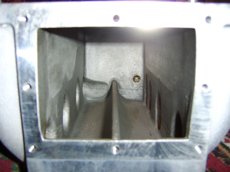 Interior view of a cast aluminum intake manifold plenum with runner openings