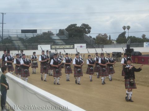 1968 Ford Mustang - A group of individuals dressed in traditional Scottish kilts participate in a parade or festival.