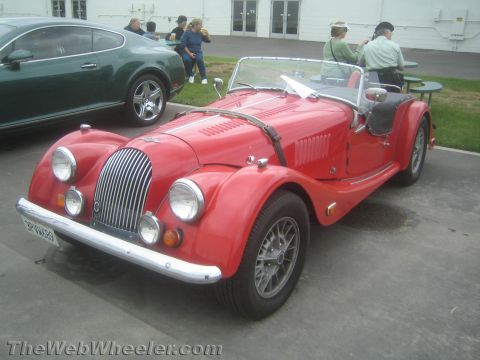 1968 Ford Mustang - Photo of a red Morgan roadster at a car show, not a technical document.