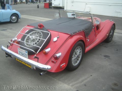 1968 Ford Mustang - Rear photo of a red Morgan roadster, not a technical document.