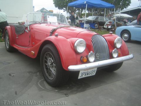 1968 Ford Mustang - Photo of a red Morgan roadster at a car show, not a technical document.