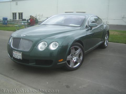 1968 Ford Mustang - Photo of a dark green Bentley Continental GT, not a technical document.