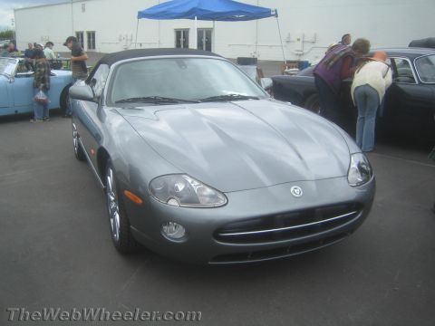 1968 Ford Mustang - Photo of a gray Jaguar XK convertible at a car show, not a technical document.