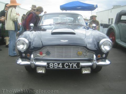 1968 Ford Mustang - Front-end photo of a dark Aston Martin DB4, not a technical document.