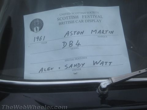 1968 Ford Mustang - Handwritten car-show display card identifying a 1961 Aston Martin DB4 and its owners.