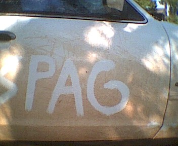 1995 Ford Crown Victoria - White spray paint spells "SPAG" on the side of a vehicle.