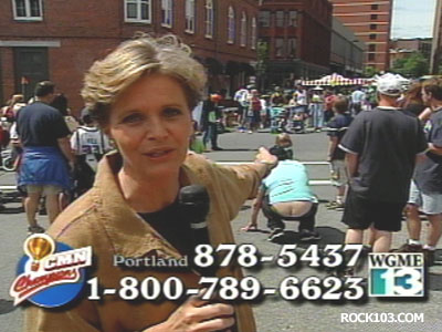 1995 Ford Crown Victoria - A reporter speaks to the camera in a crowded street scene with overlaid graphics.