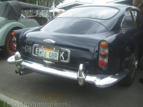 1968 Ford Mustang - Rear photo of a dark blue classic Aston Martin, not a technical document.